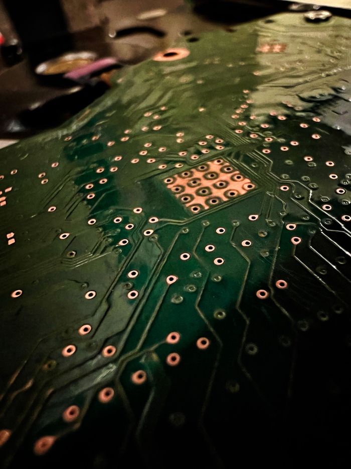 A close-up photo highlighting the intricate design of a circuit board PCB with visible connections and solder joints.